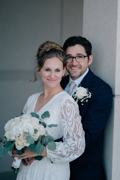 Couple posing for a shot with bright eyes and cute smiles.