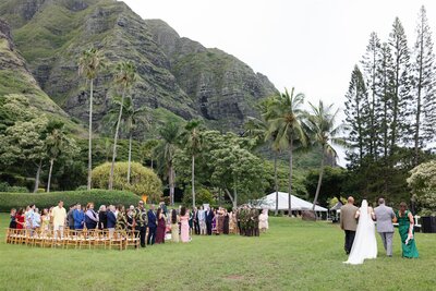 A person walking down the aisle with their family on their wedding day 