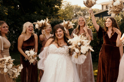 bridesmaids standing smiling at each other
