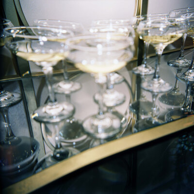 candid detail shot of glasses of champaign being  handed out to guests as they enter the reception.