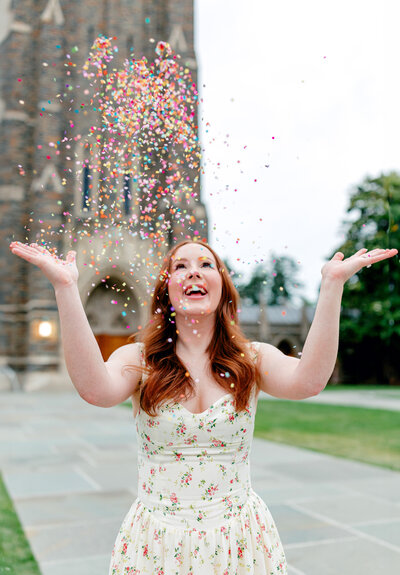 Graduation portrait featuring a student surrounded by colorful confetti.