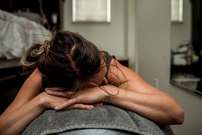 Pregnant person resting in labor with hand held supportively