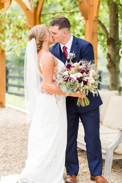 bride and groom kissing on their wedding day at Rivercrest Farm