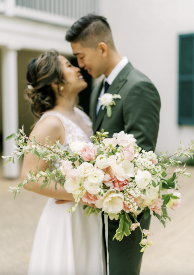 Lush wedding flowers featuring garden roses, double tulips, and spirea branches. Custom floral design by The Garden Studio LLC, a wedding florist in Easton, MD. Garden inspired floral design.