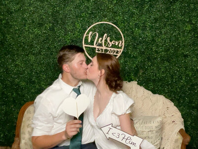 bride and groom hugging with touching foreheads in front of water