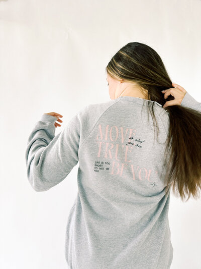 woman wearing grey oversized crewneck