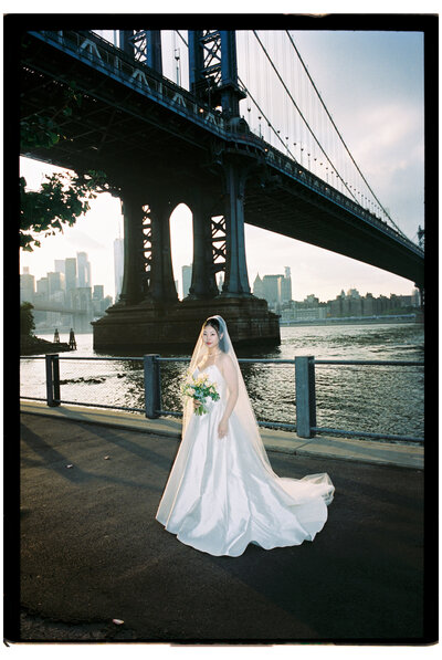 Bride. in front of bridge by destination wedding photographer​ Noble Photo Co