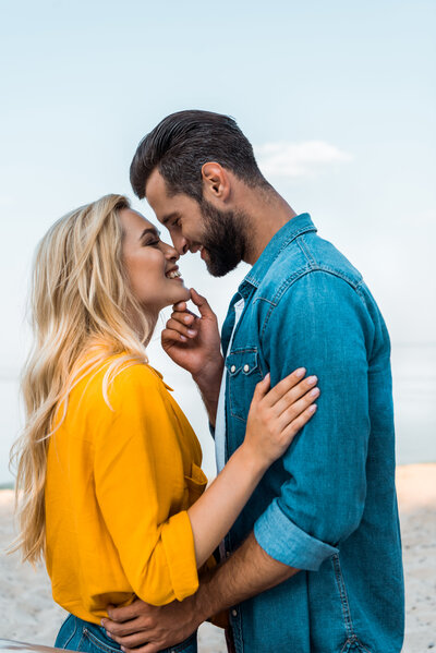 side-view-of-smiling-couple-touching-with-noses-on-RQBXUUE