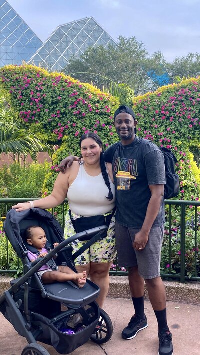 Amanda with her husband and eldest daughter at disney world.