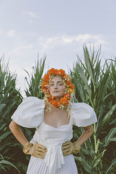 woman in a wedding dress in front of a corn field