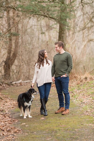 Couple walking in park with dog