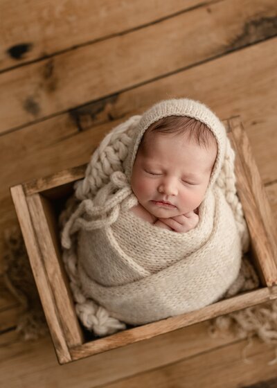 Newborn wrapped in neutral tones at Fort Collins studio session