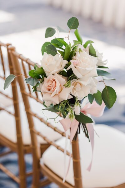Whte floral accent on ceremony chair