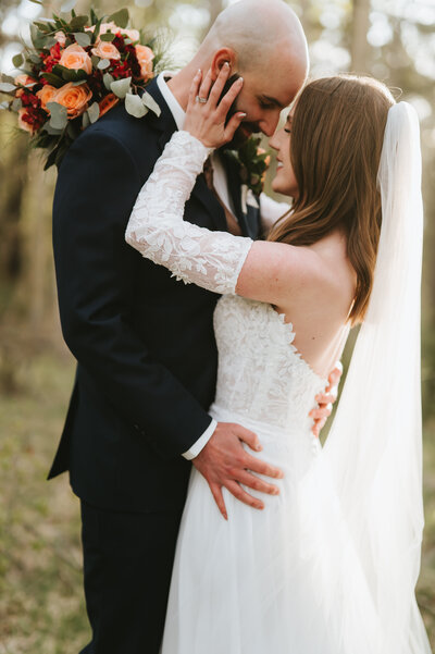 groom holding bride's face at los poblanos organic farm