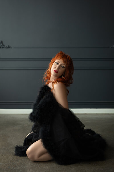 woman in a red lingerie set sitting on a chair in the kitchen