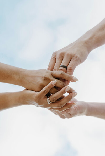 hands holding each other showing wedding rings