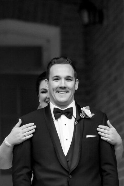 Bride with ginger hair walking in sunlight with groom hand in hand