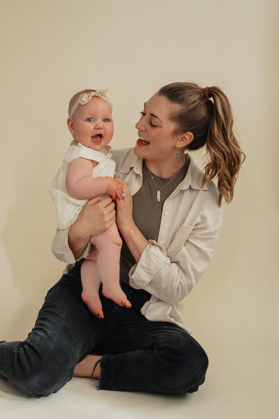 woman smiling while holding baby