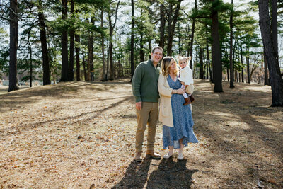 Family of three playing in nature at Central Park in Schenectady, New York