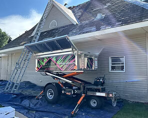 Equipter 4000 dumpster raised to roof for shingles to be thrown into