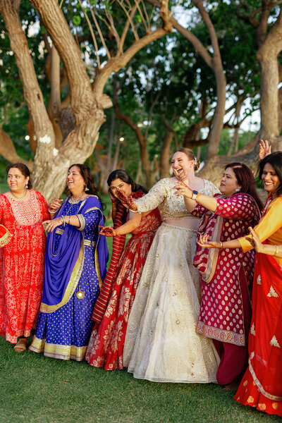 Newlyweds smiling and laughing with wedding guests 