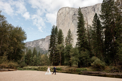 A bride and groom laugh together in front of a beautiful mountain view on their mammoth lakes wedding day. 