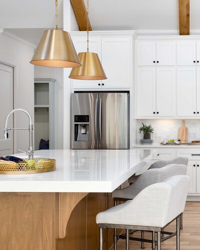 White cabients and gold pendants tulsa kitchen boulevard interiors