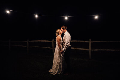 Bride and Groom sharing a kiss after dark at wedding