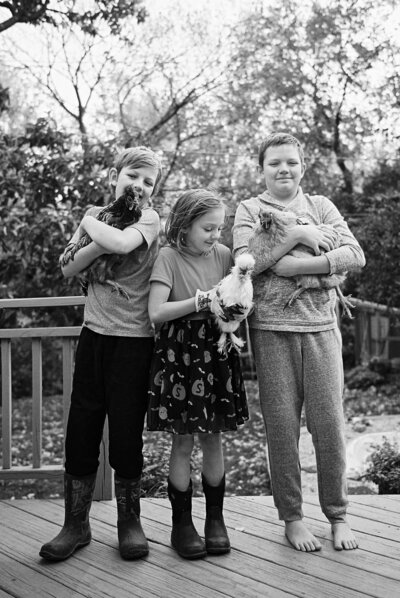 Sherah Grose with her husband and three children smiling together outdoors on a sunny path.