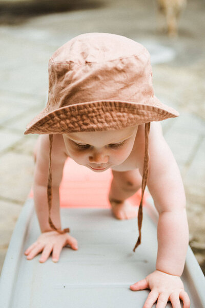 An adorable outdoor photo of a baby exploring, taken by a Cleveland family photographer during a lifestyle session.
