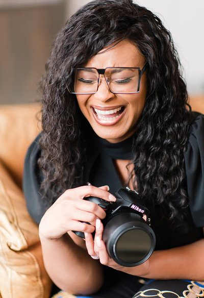 Marcella Colette laughing hard while holding camera