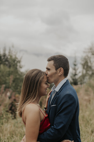 kiss on the forehead of a couple during an elopement in the French Alps