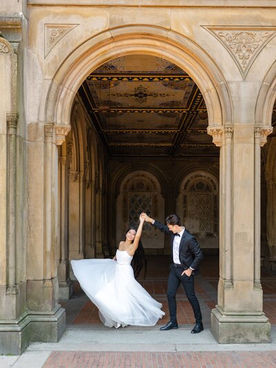 A newlywed couple twirling in Central Park New York City
