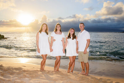 Family photo at Kapalua Bay during a sunset session with Mariah Milan Photographers.
