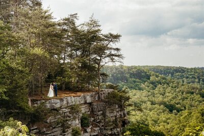 couple captured under a waterfall by birmingham alabama wedding photographer