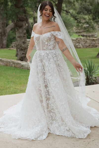 black and white image bride wearing  lace wedding dress with long veil