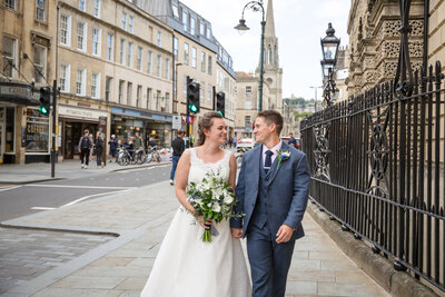 Bride and Groom walking in the streets of Bath on their wedding day