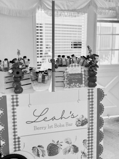 Black and white image of berry themed birthday party signage and decor planned by Fancy Chancey in San Diego CA