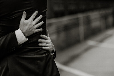 Groom's holding each other romantically on their wedding day