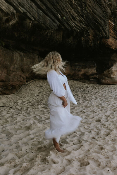 Blurry image of woman dancing/running on the beach 