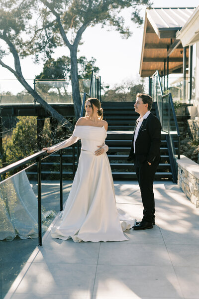 Groom posing with hands around bride