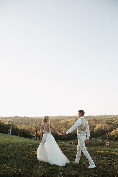 couple walking during a wedding day photo session in montana