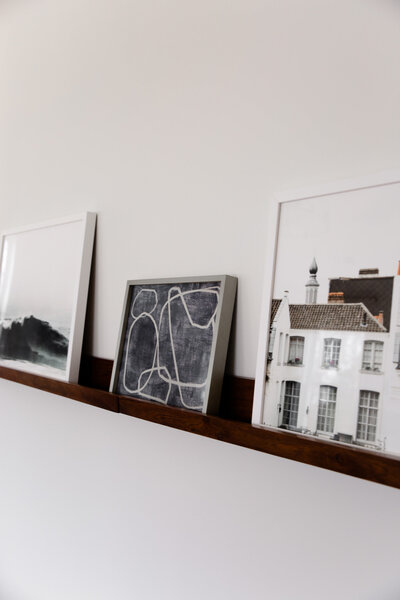 minimalistic dark wood shelf with photographs