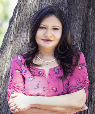 Staff headshot in front of neutral background.