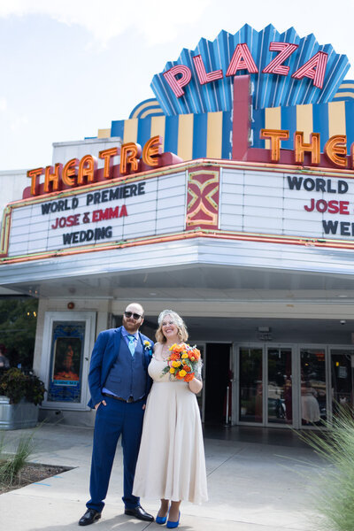 Bride and groom with marquee at Plaza Theatre