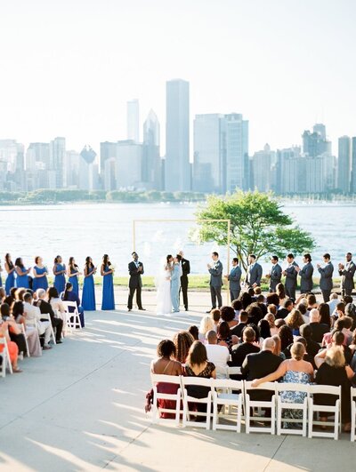 Bride in custom wedding gown standing in front of Chicago skyline