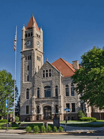 Historic courthouse building in Xenia, Ohio with clock tower and American flag.