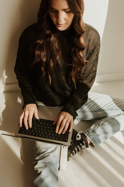 Relaxed brand portrait captured by Sunshine Coast photographer, featuring a woman enjoying coffee in a soft-lit setting.
