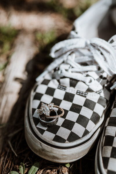 Engagement and wedding rings on checkerboard Vans, unique detail photo from Breckenridge elopement photography team.