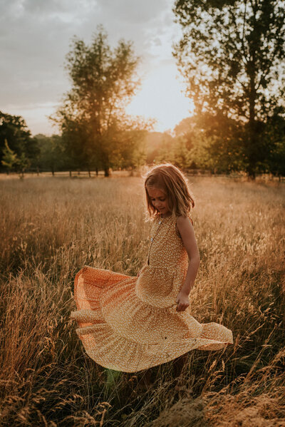 Portrait of child in field at sunset